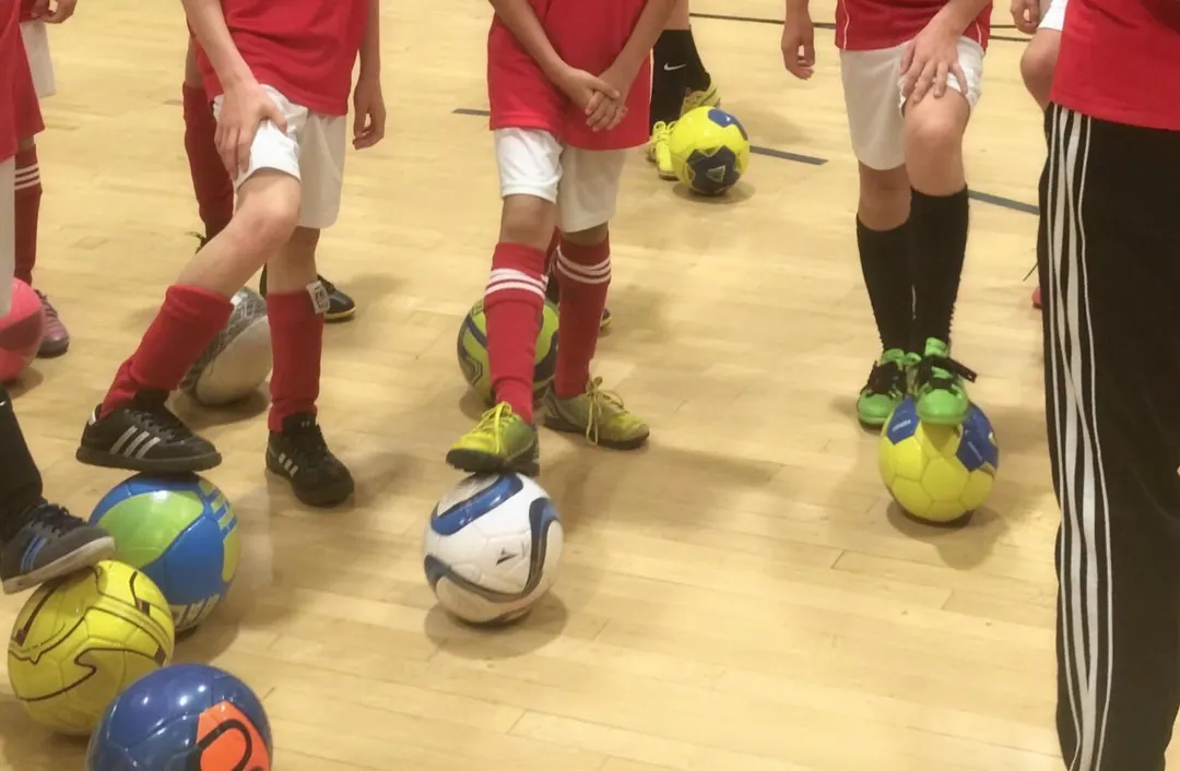 Players lined up in club kit, each with a ball at their feet